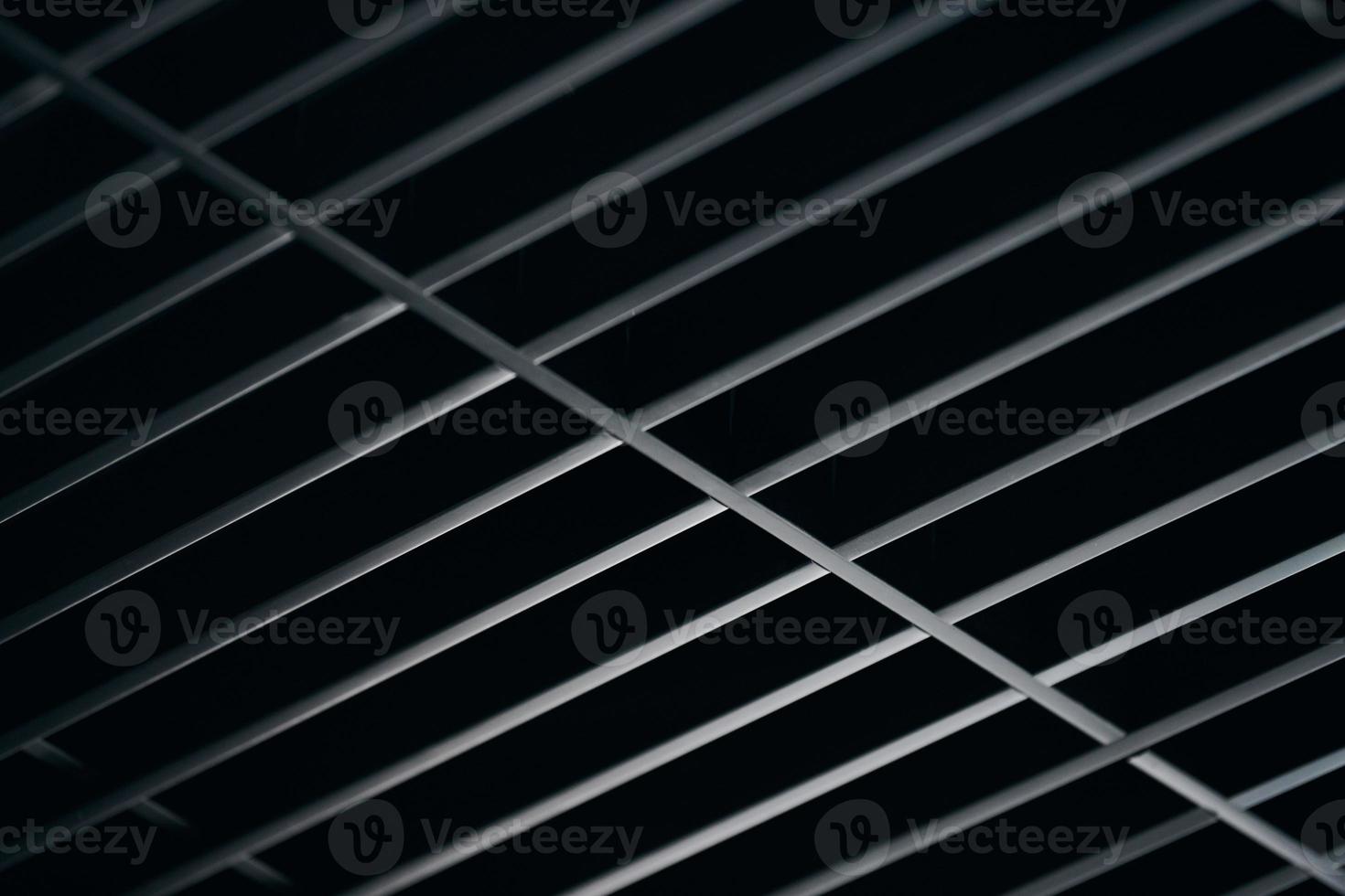 Office grille ceiling. Modern black metal grille ceiling, suspended covering. Abstract design texture. photo