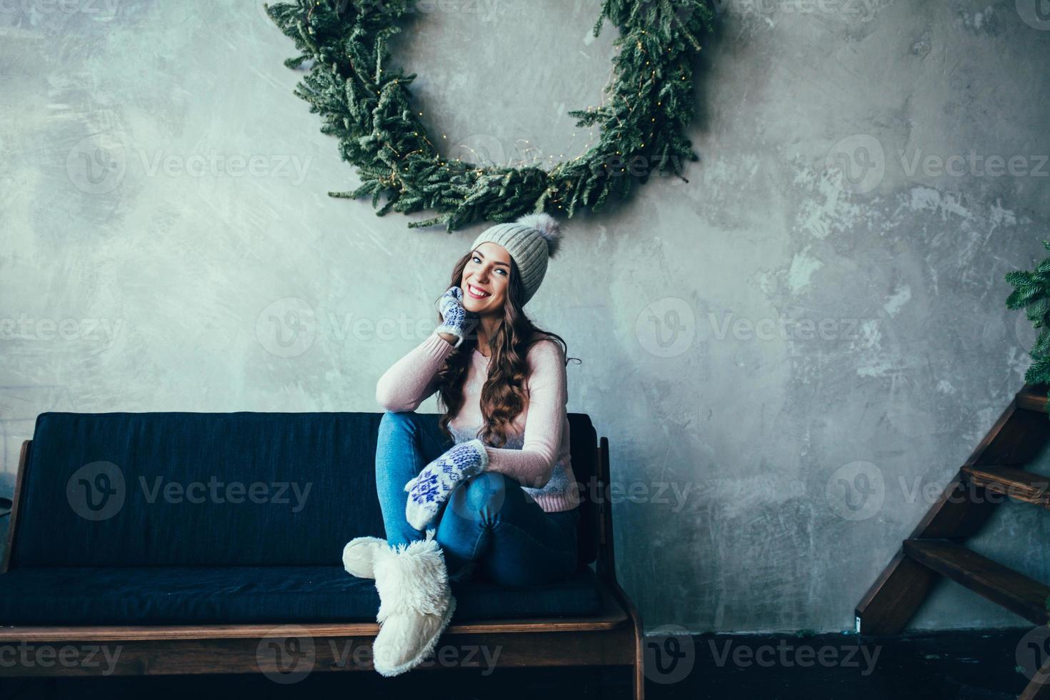 Young woman sitting on sofa photo