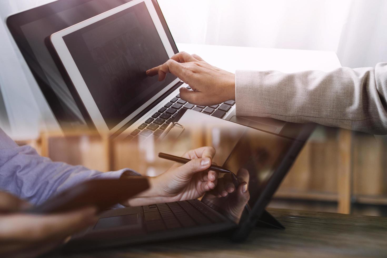 businesswoman hand working with laptop computer, tablet and smart phone in modern office with virtual icon diagram at modernoffice in morning light photo