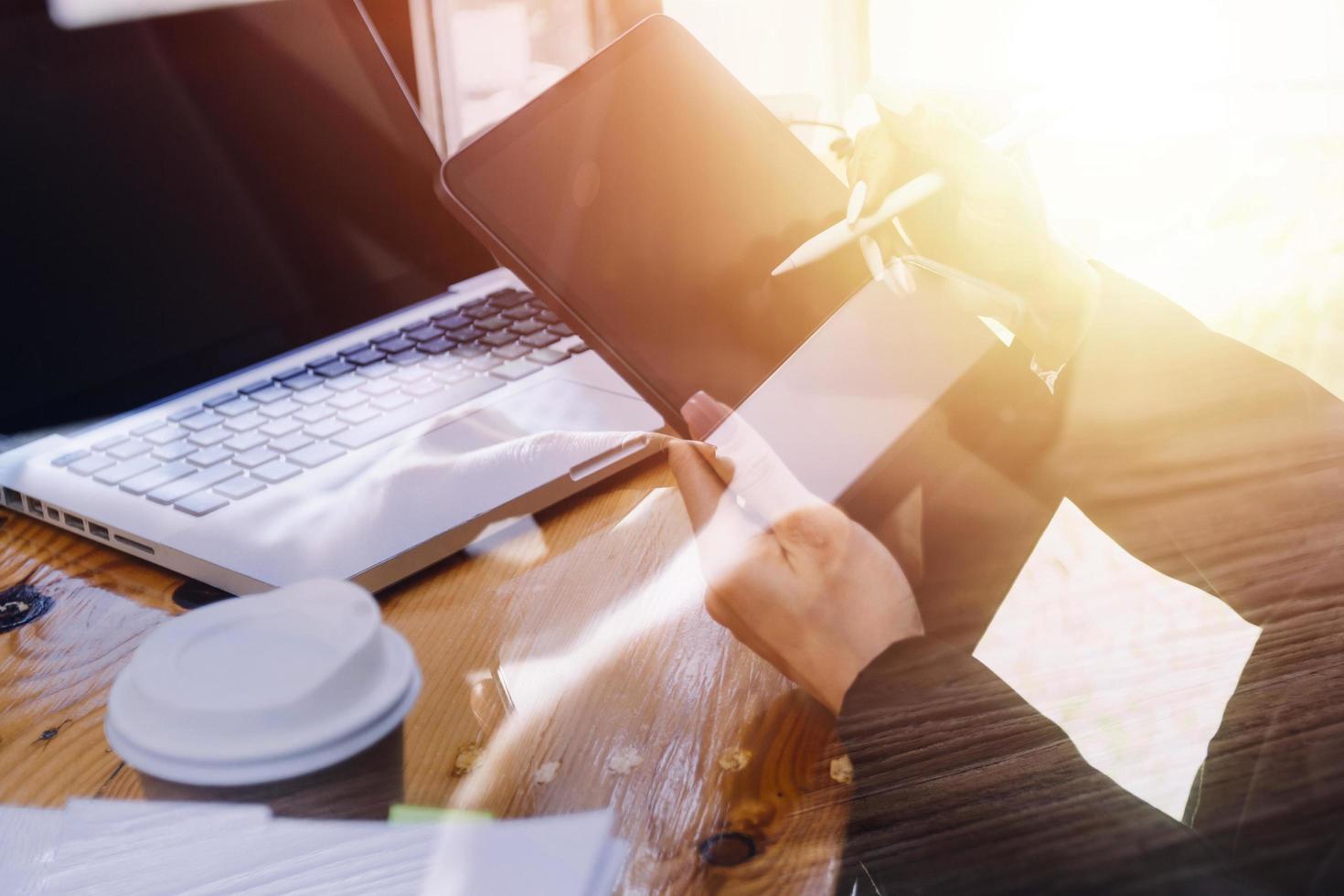 businesswoman hand working with laptop computer, tablet and smart phone in modern office with virtual icon diagram at modernoffice in morning light photo
