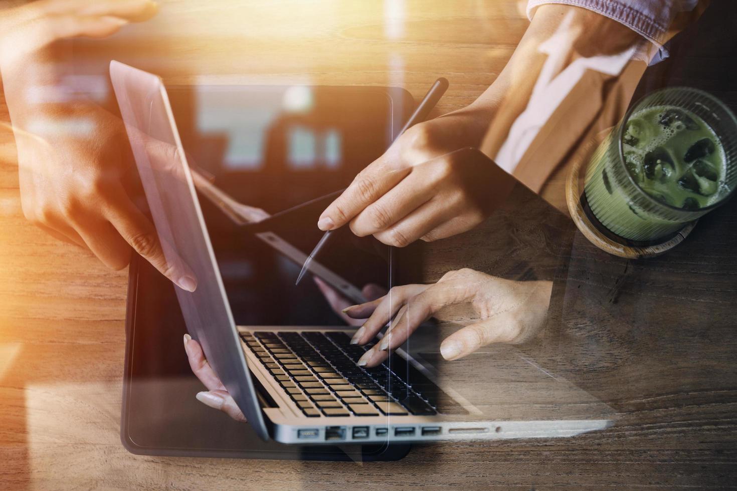 businesswoman hand working with laptop computer, tablet and smart phone in modern office with virtual icon diagram at modernoffice in morning light photo