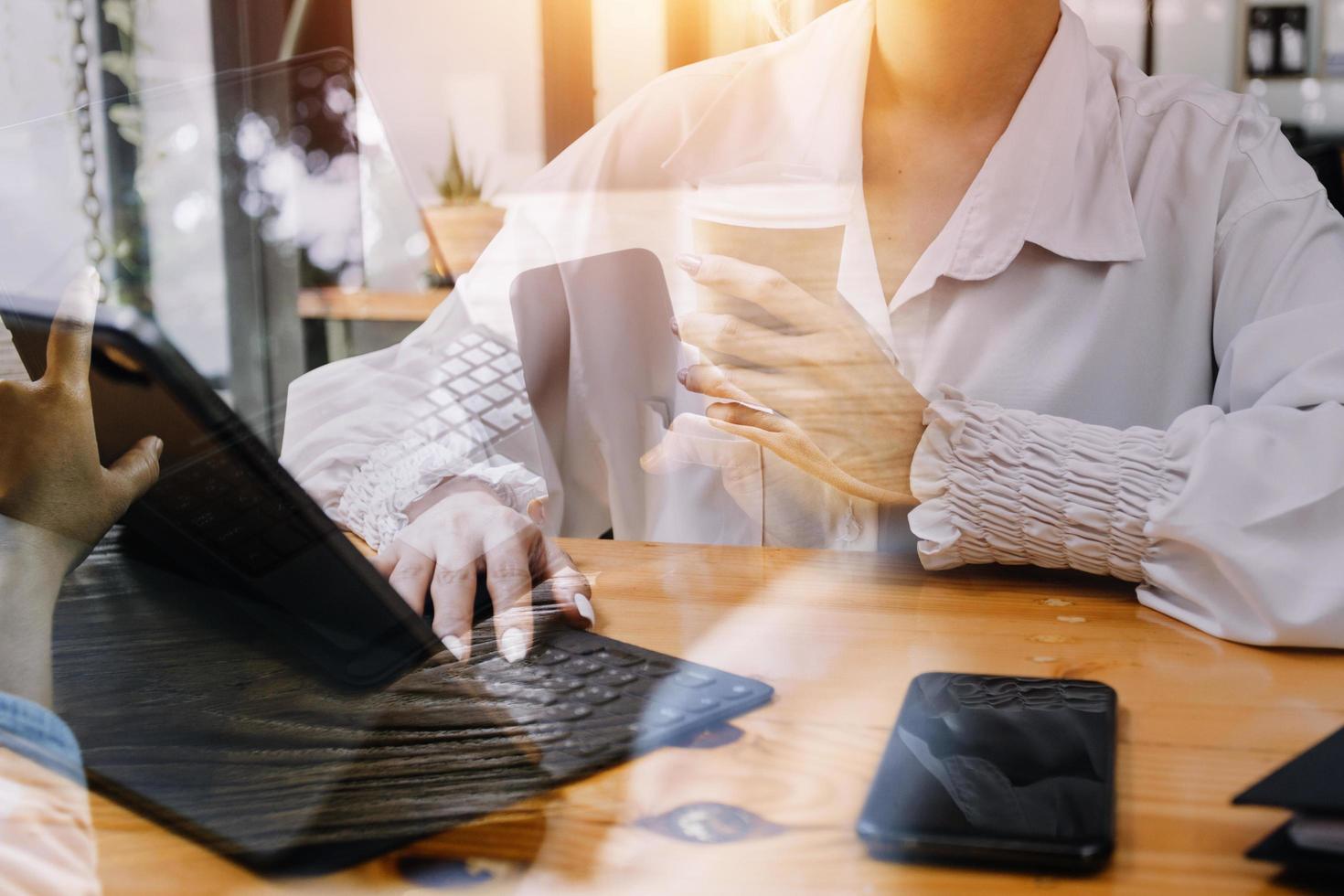businesswoman hand working with laptop computer, tablet and smart phone in modern office with virtual icon diagram at modernoffice in morning light photo