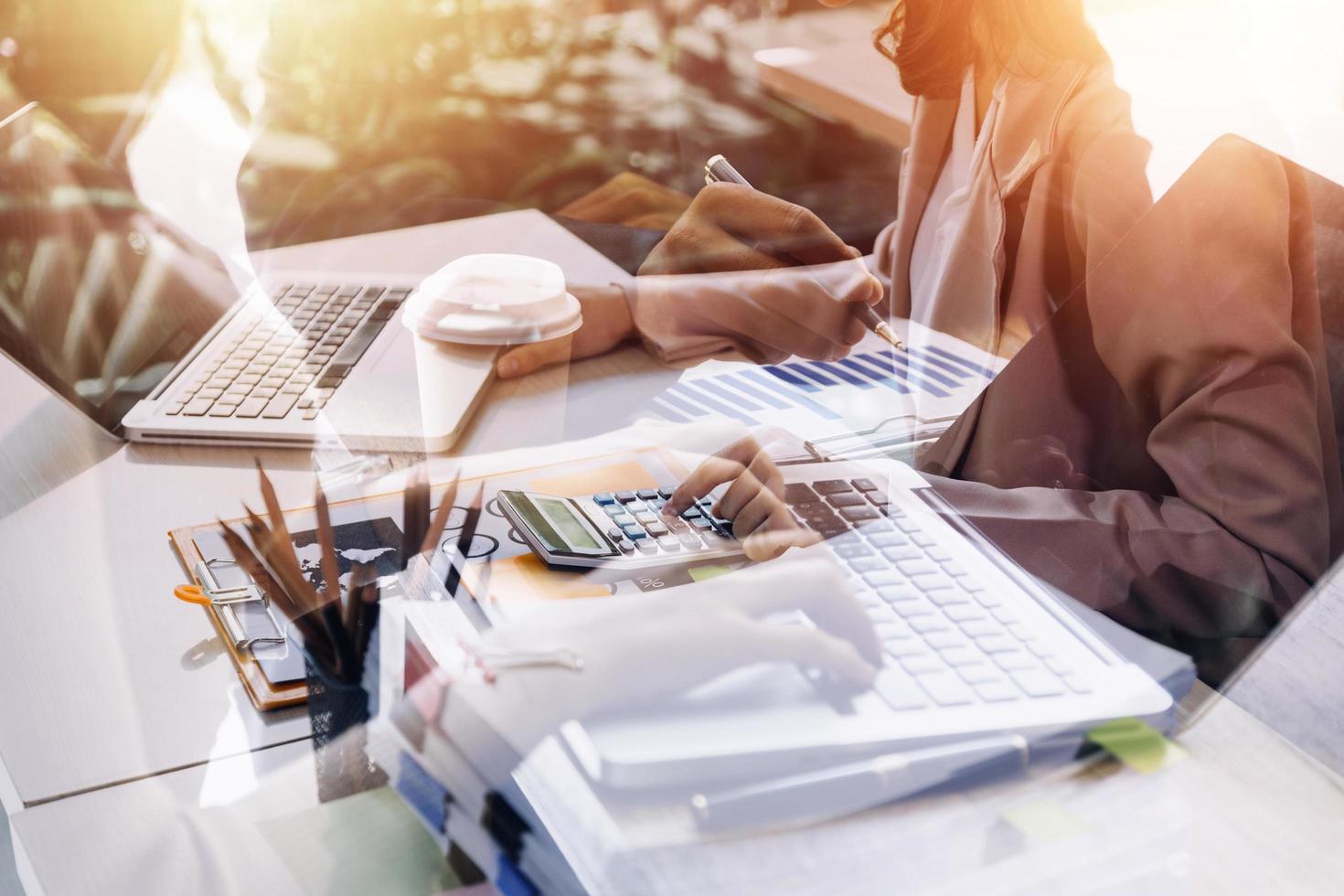 businesswoman hand working with laptop computer, tablet and smart phone in modern office with virtual icon diagram at modernoffice in morning light photo