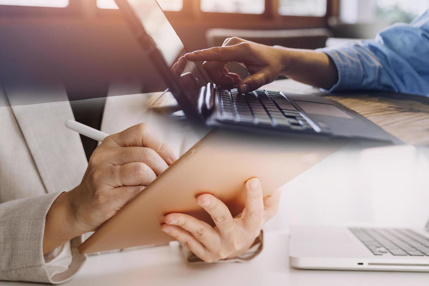 businesswoman hand working with laptop computer, tablet and smart phone in modern office with virtual icon diagram at modernoffice in morning light photo