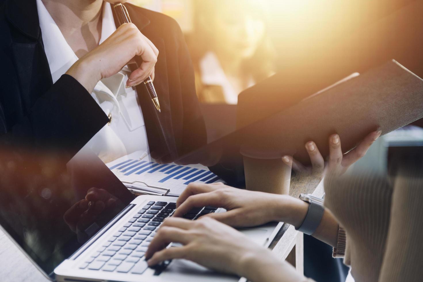 businesswoman hand working with laptop computer, tablet and smart phone in modern office with virtual icon diagram at modernoffice in morning light photo