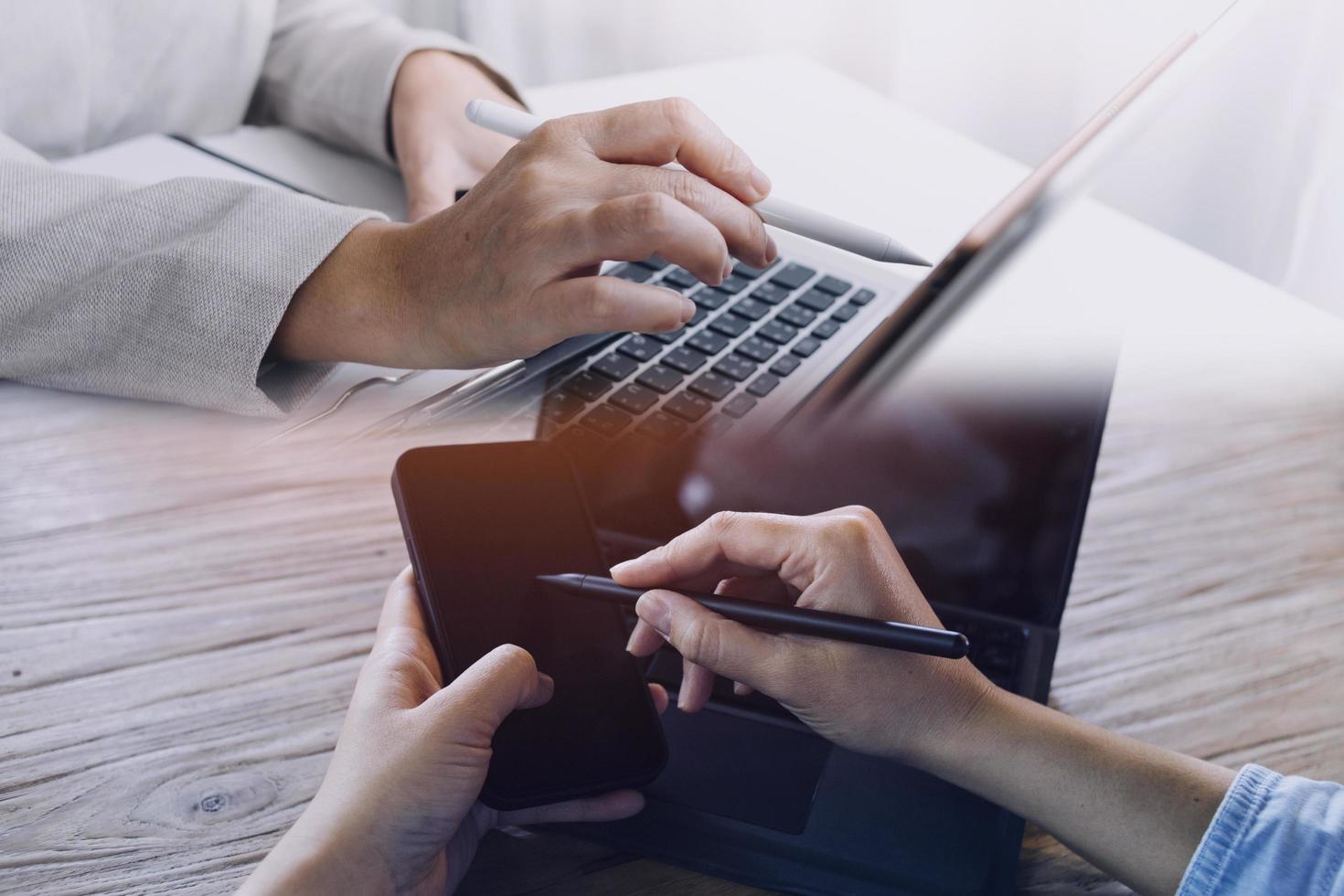 businesswoman hand working with laptop computer, tablet and smart phone in modern office with virtual icon diagram at modernoffice in morning light photo