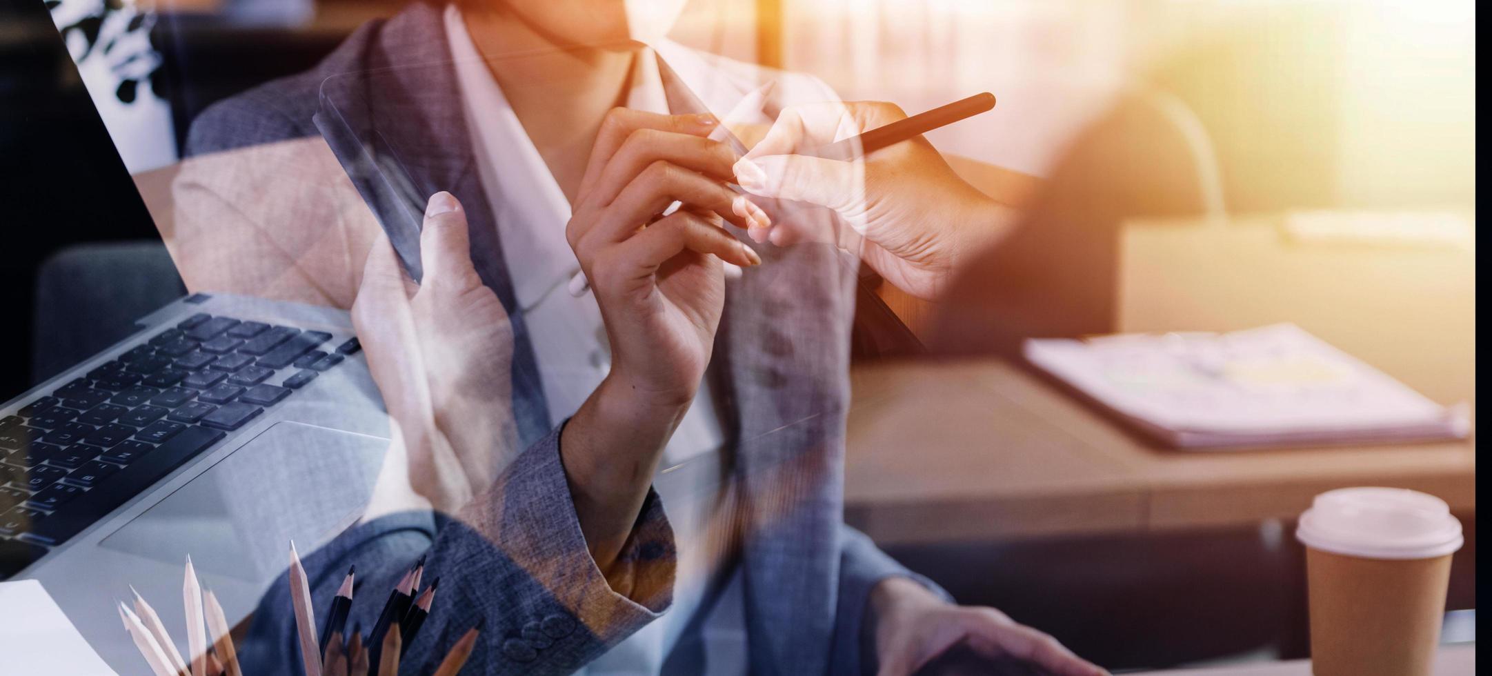 businesswoman hand working with laptop computer, tablet and smart phone in modern office with virtual icon diagram at modernoffice in morning light photo