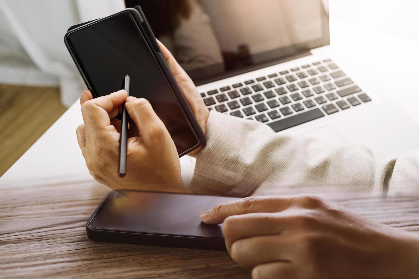businesswoman hand working with laptop computer, tablet and smart phone in modern office with virtual icon diagram at modernoffice in morning light photo