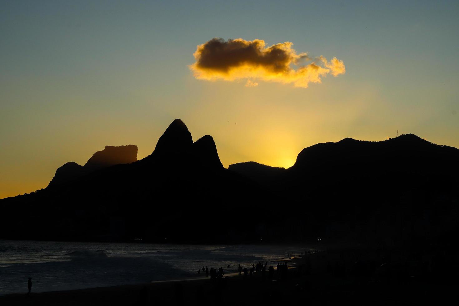 Rio de Janeiro, RJ, Brazil, 2022 - Ipanema at sunset, people walking on the beach in silhouette photo