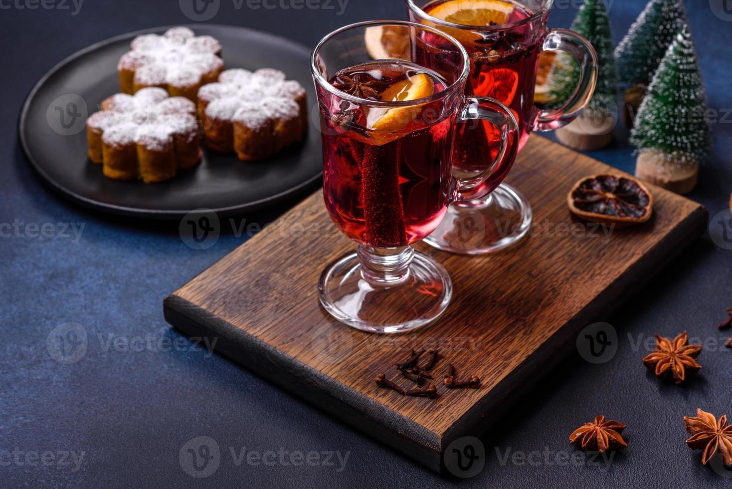 Hot mulled wine with a slice of orange, with cinnamon, cloves and other spices photo