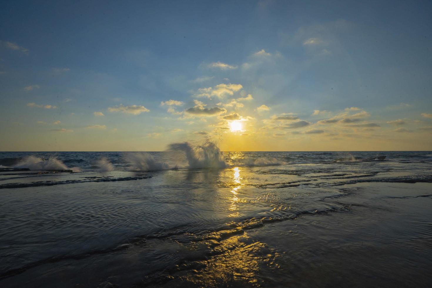 Beautiful view of the sea with the sun shining in a blue sky in the background photo