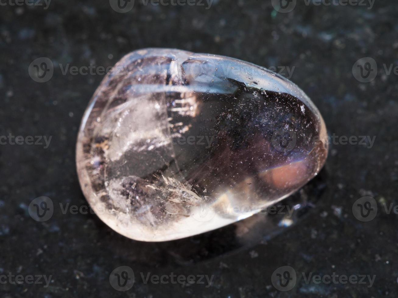 tumbled smoky quartz gemstone on dark photo