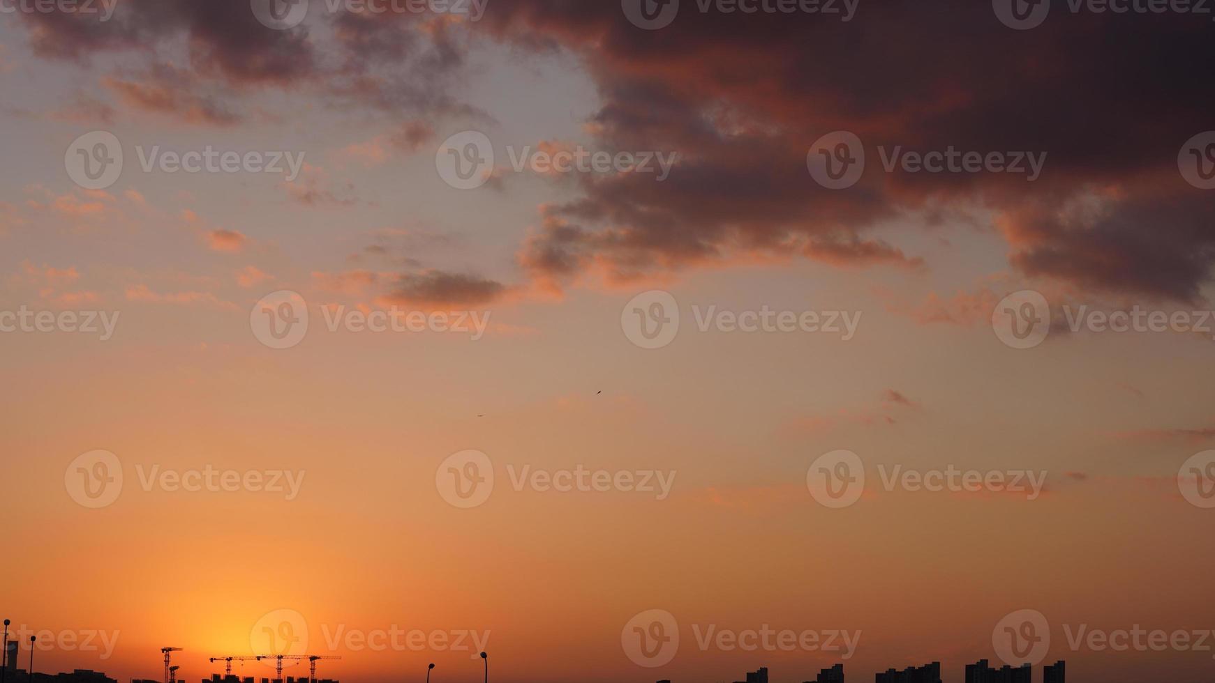 The beautiful sunset view with the colorful clouds and sky in the city photo