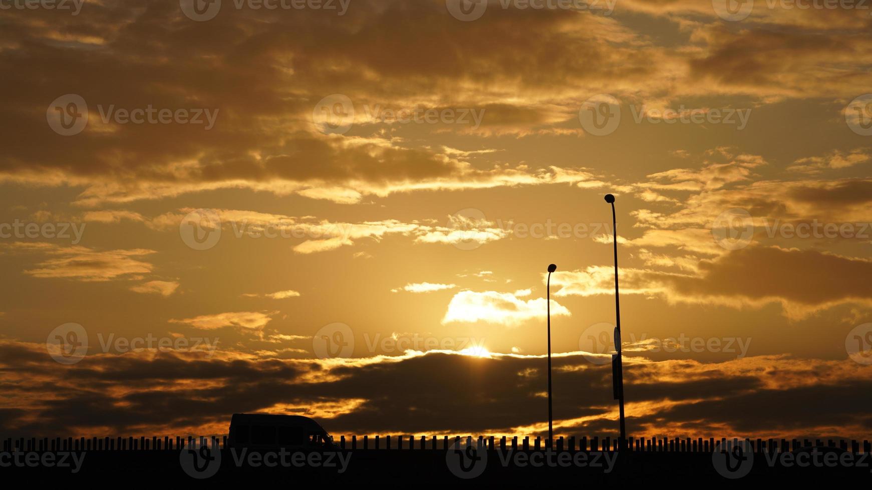 The beautiful sunset view with the colorful clouds and sky in the city photo