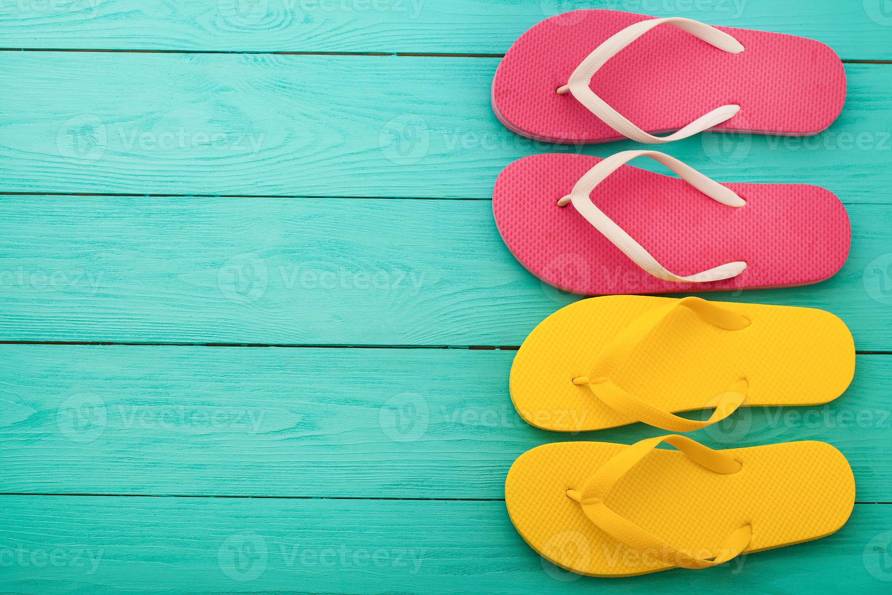 flip flops on blue wooden background with copy space. Beach accessories