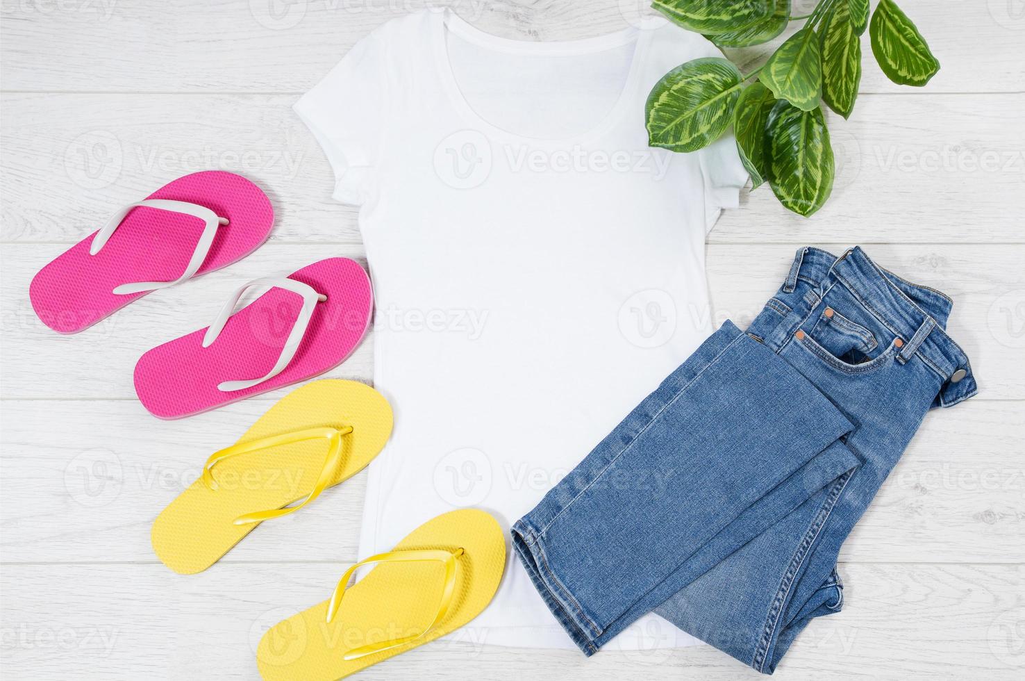 White female t shirt flip flops mock up flat lay on wooden background. Top view and copy space. Mockup t-shirt and summertime. Template blank shirt. photo