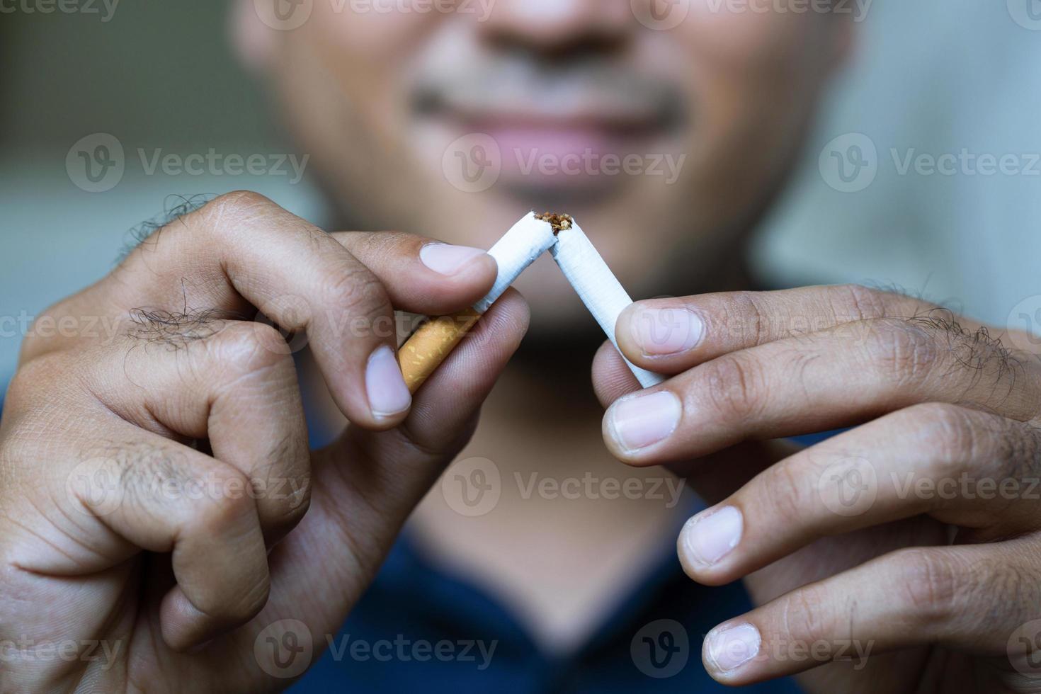 Man refusing cigarettes concept for quitting smoking and healthy lifestyle dark  background. or No smoking campaign Concept. photo