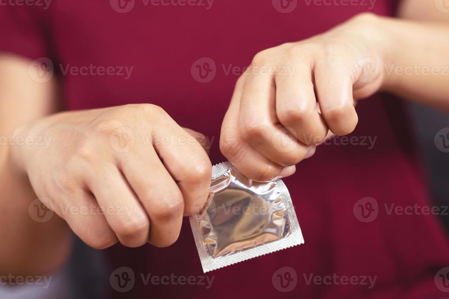 Woman is using condom to prevent AIDS. photo