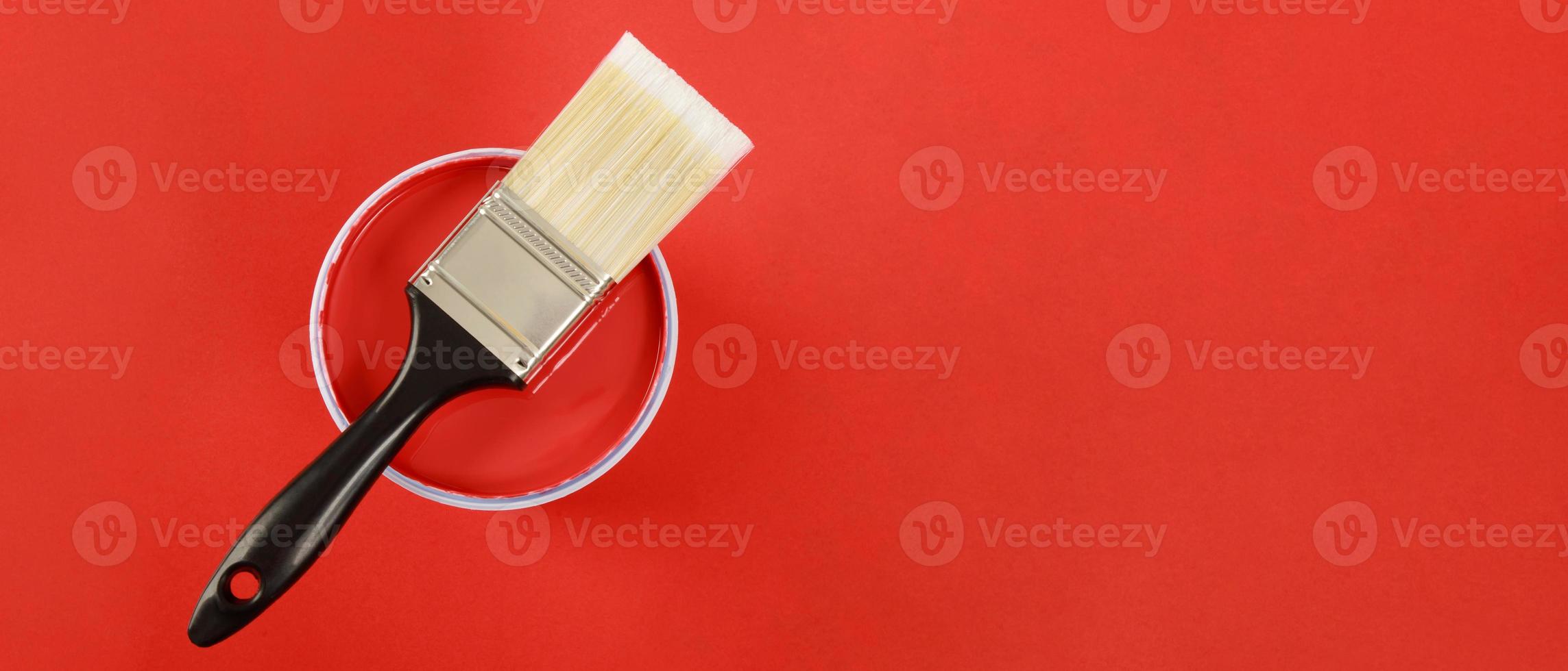 The cans of interior wall paint is placed on a red background. photo
