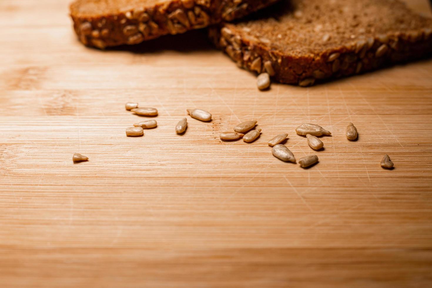 Sliced bread on a wooden table  with sunflower seeds photo