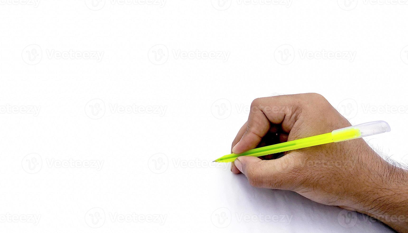 Man's hand holding pen and writing on virtual screen isolated on white background photo