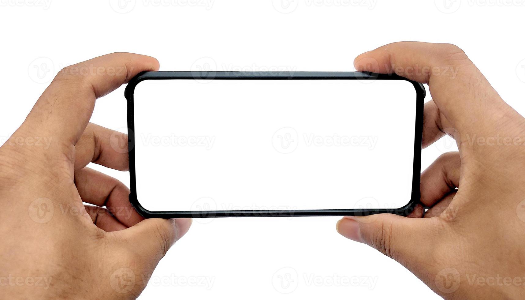 Man holding smartphone with blank screen on white background, closeup of hand. Space for text photo