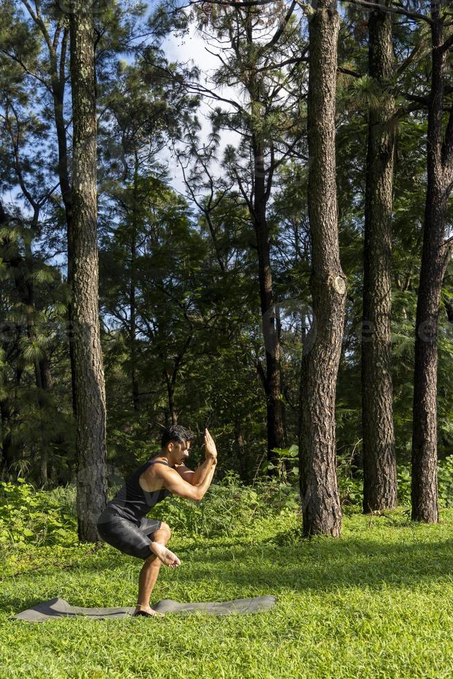 young man, doing yoga or reiki, in the forest very green vegetation, in mexico, guadalajara, bosque colomos, hispanic, photo