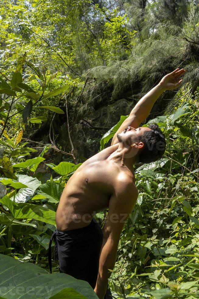 man seen up close, without shirt doing stretches on yoga mat, exercise, latin america photo