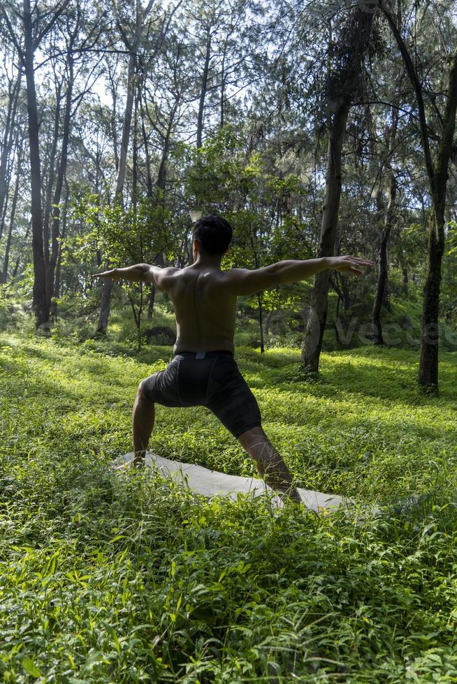 man seen up close, without shirt doing stretches on yoga mat, exercise, latin america photo