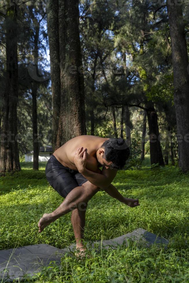 young man, doing yoga or reiki, in the forest very green vegetation, in mexico, guadalajara, bosque colomos, hispanic, photo