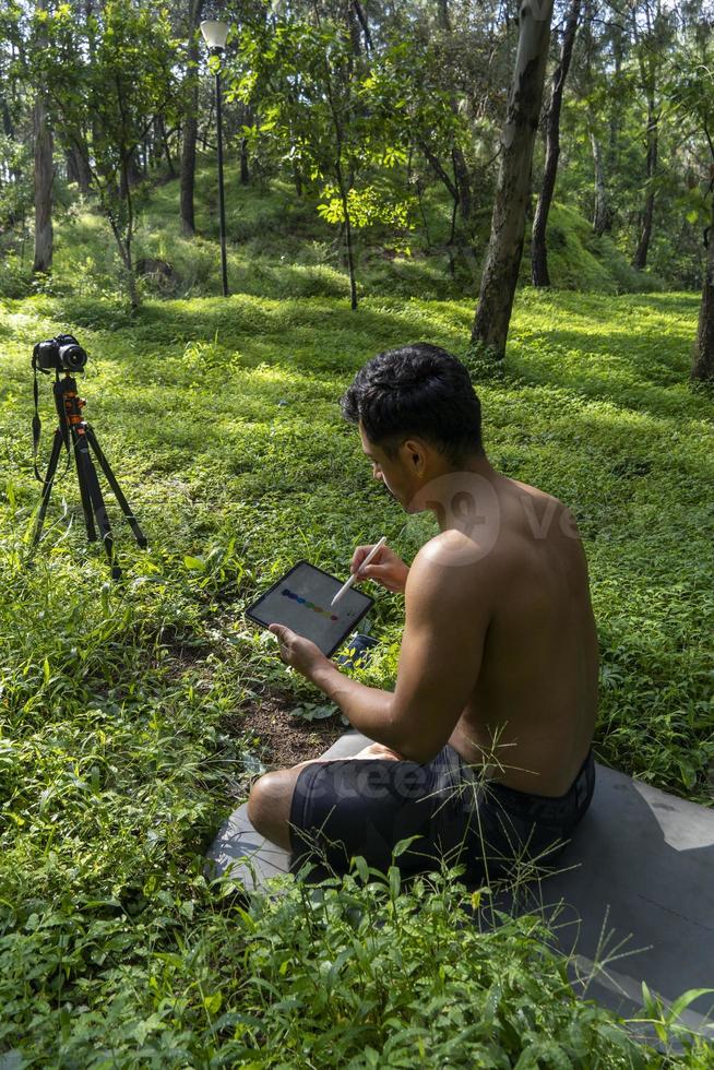 young man athletic body, drawing the chakaras, while explaining them in class online, mexico latin america photo
