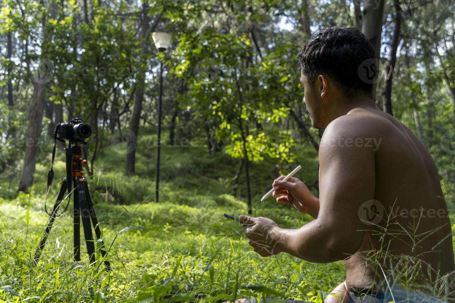 hispanic latino man giving class, while being recorded by a camera, holding ipad or tablet in his hand, mexico photo