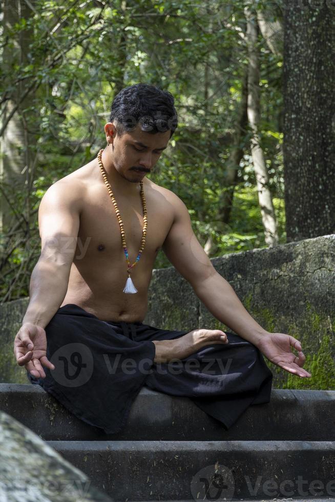 man seen up close, without shirt doing stretches on yoga mat, exercise, latin america photo