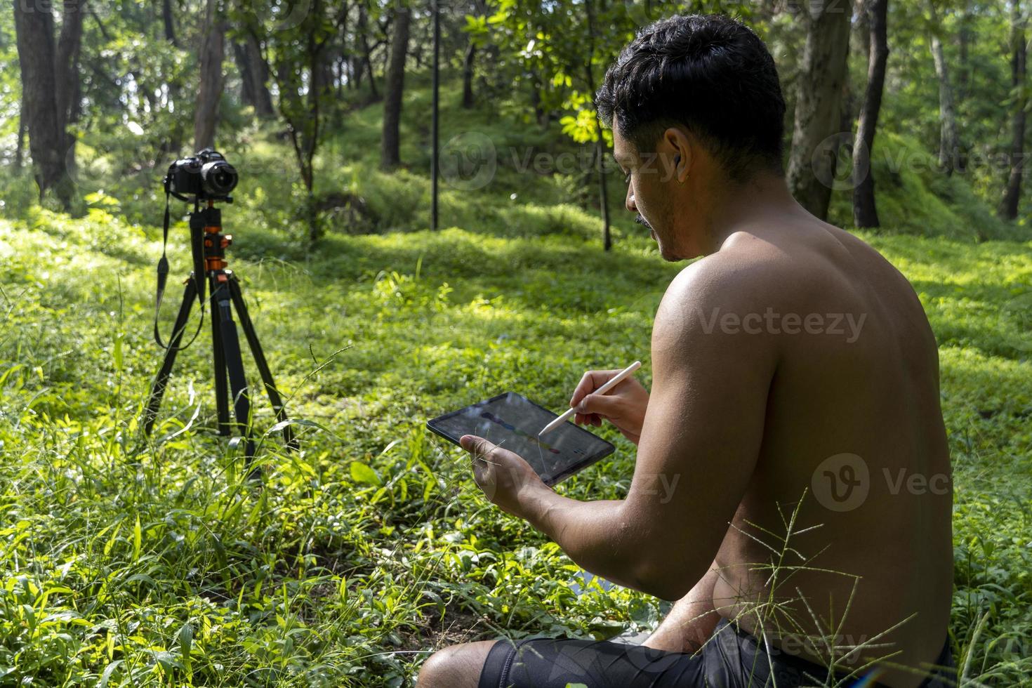 young man athletic body, drawing the chakaras, while explaining them in class online, mexico latin america photo