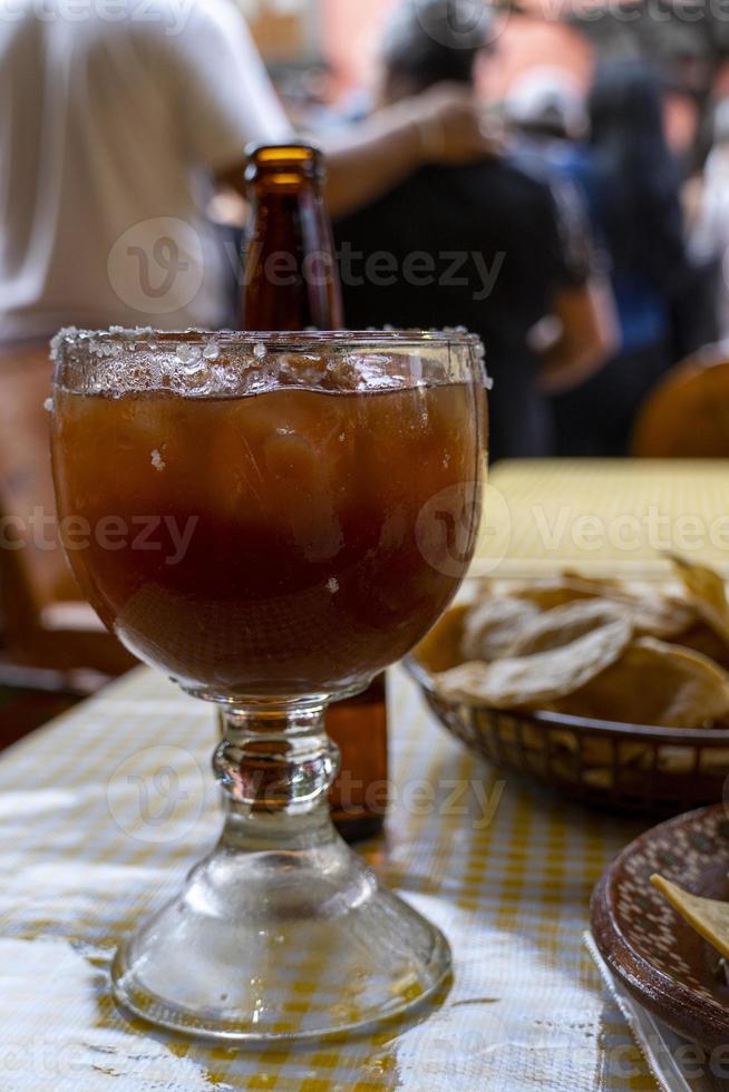 A view of a michelada beverage among a variety of Mexican photo