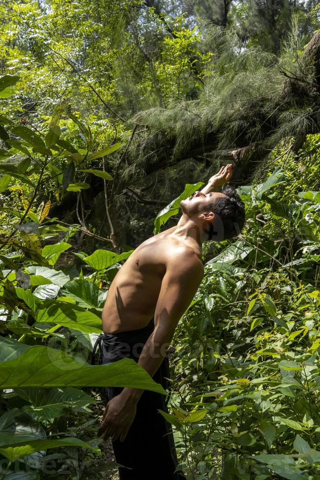 man seen up close, without shirt doing stretches on yoga mat, exercise, latin america photo