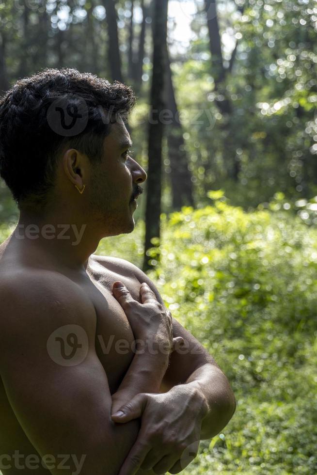 man seen up close, without shirt doing stretches on yoga mat, exercise, latin america photo