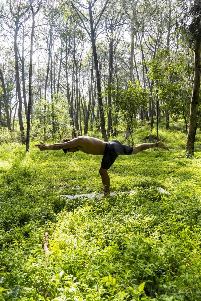 mexican man doing yoga and stretching in the forest, mexico photo