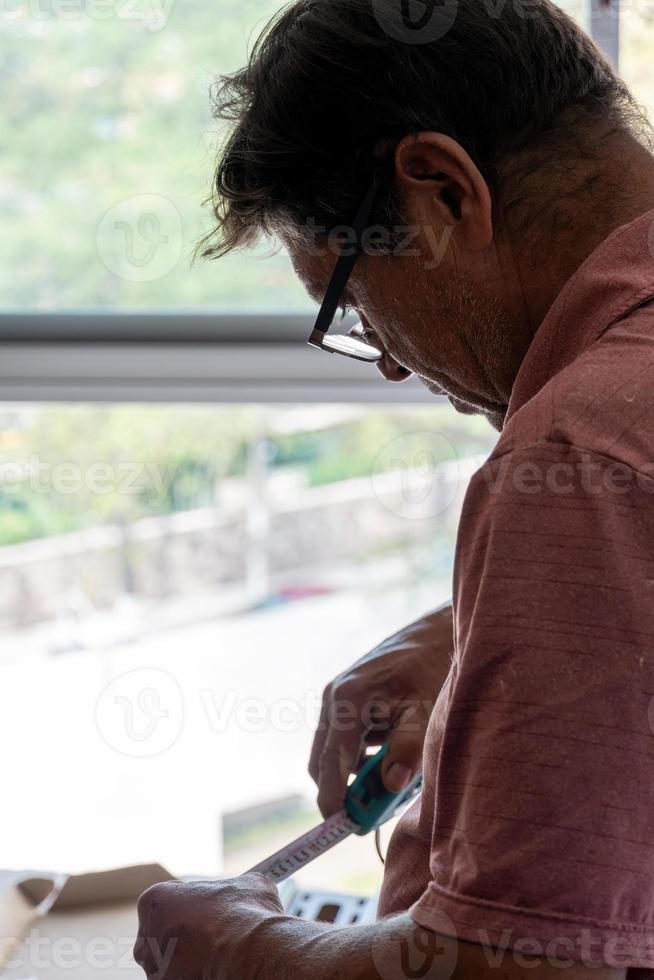 Handyman using screwdriver to fix tv, repair and installation services photo