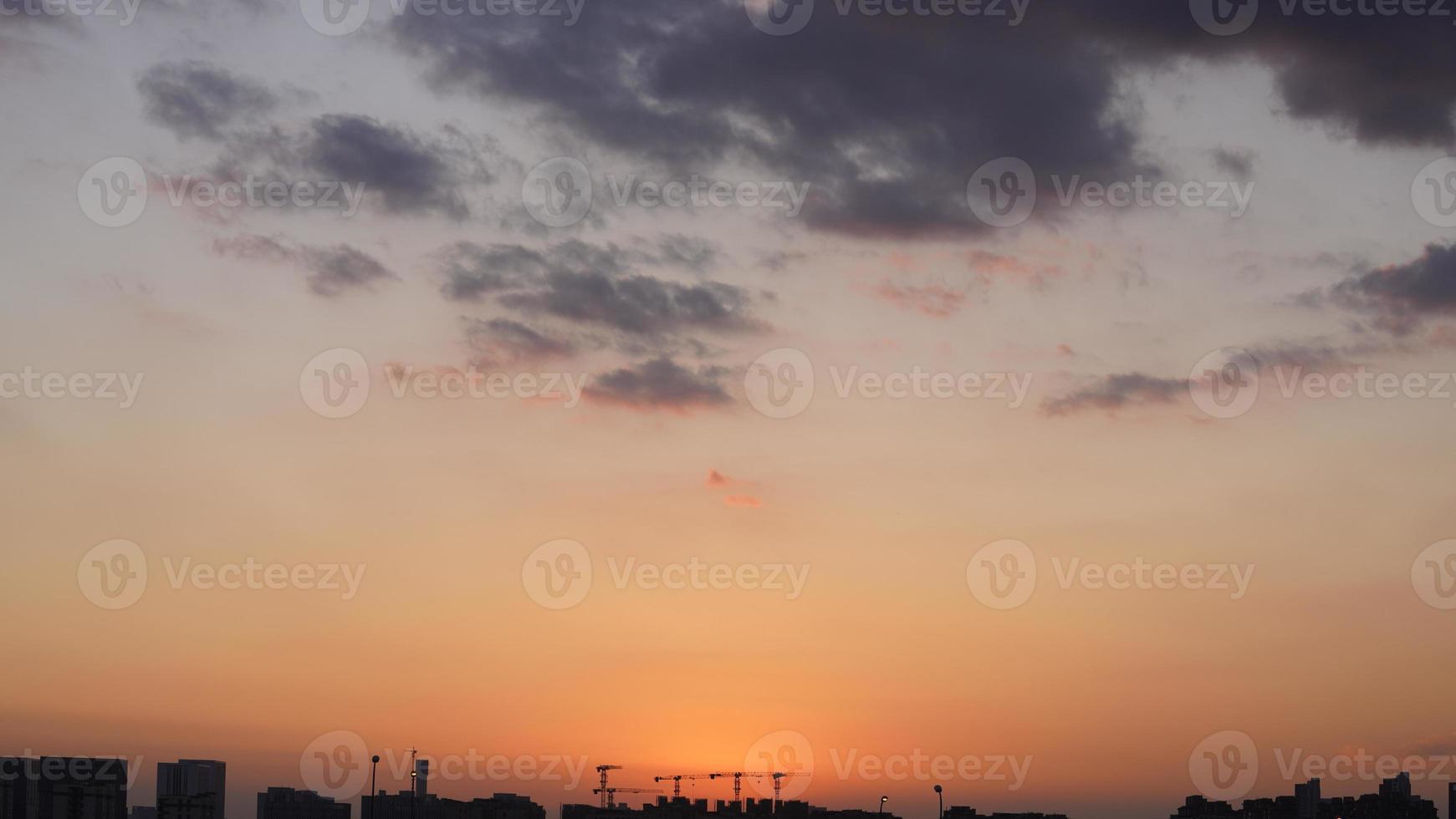 The beautiful sunset view with the colorful clouds and sky in the city photo