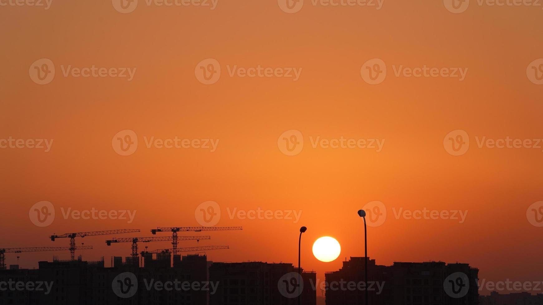 The beautiful sunset view with the colorful clouds and sky in the city photo