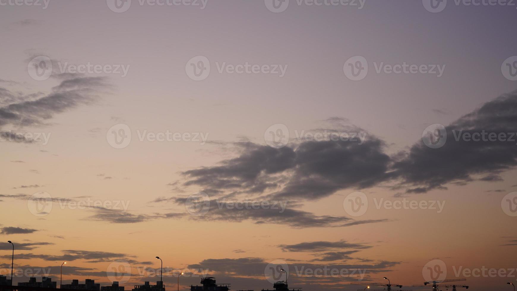 The beautiful sunset view with the colorful clouds and sky in the city photo