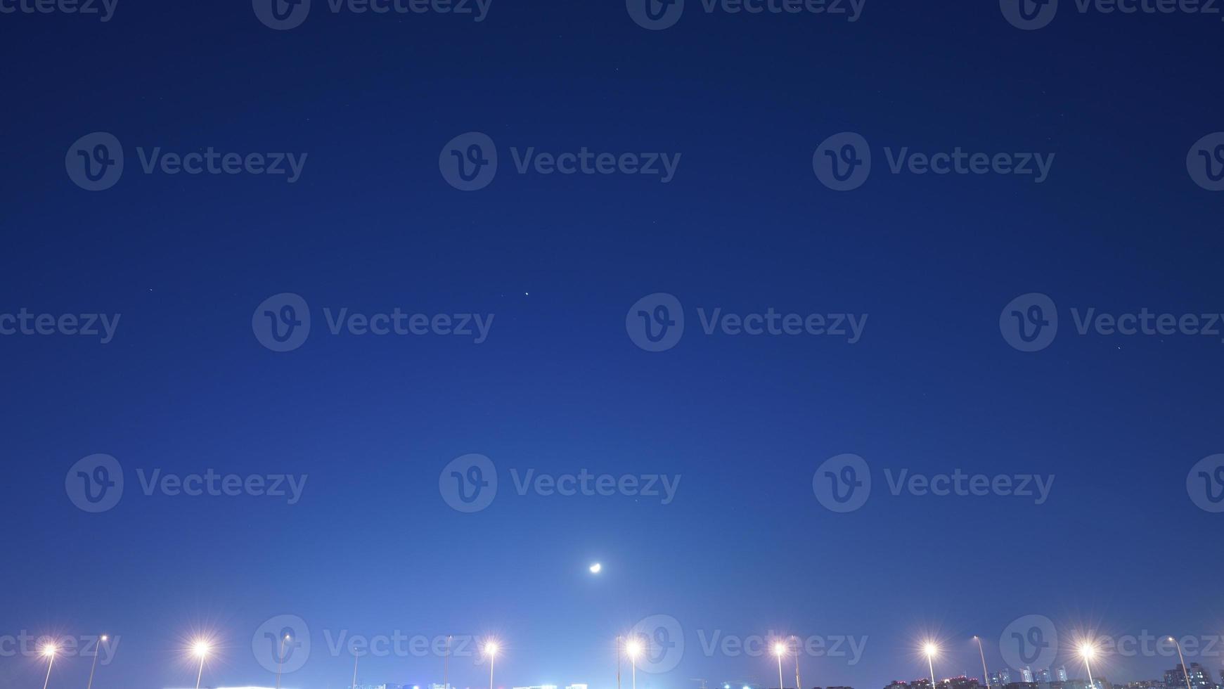 The moon night view with the bright moon in the dark sky at night photo