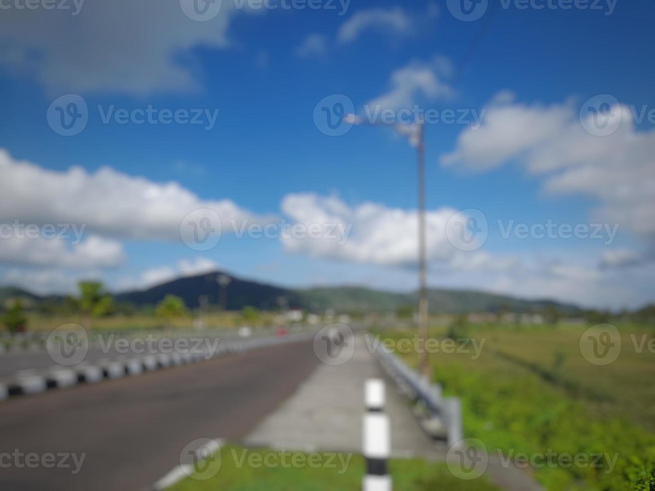 Defocused abstract blured  of highway with blue sky background with few clouds photo