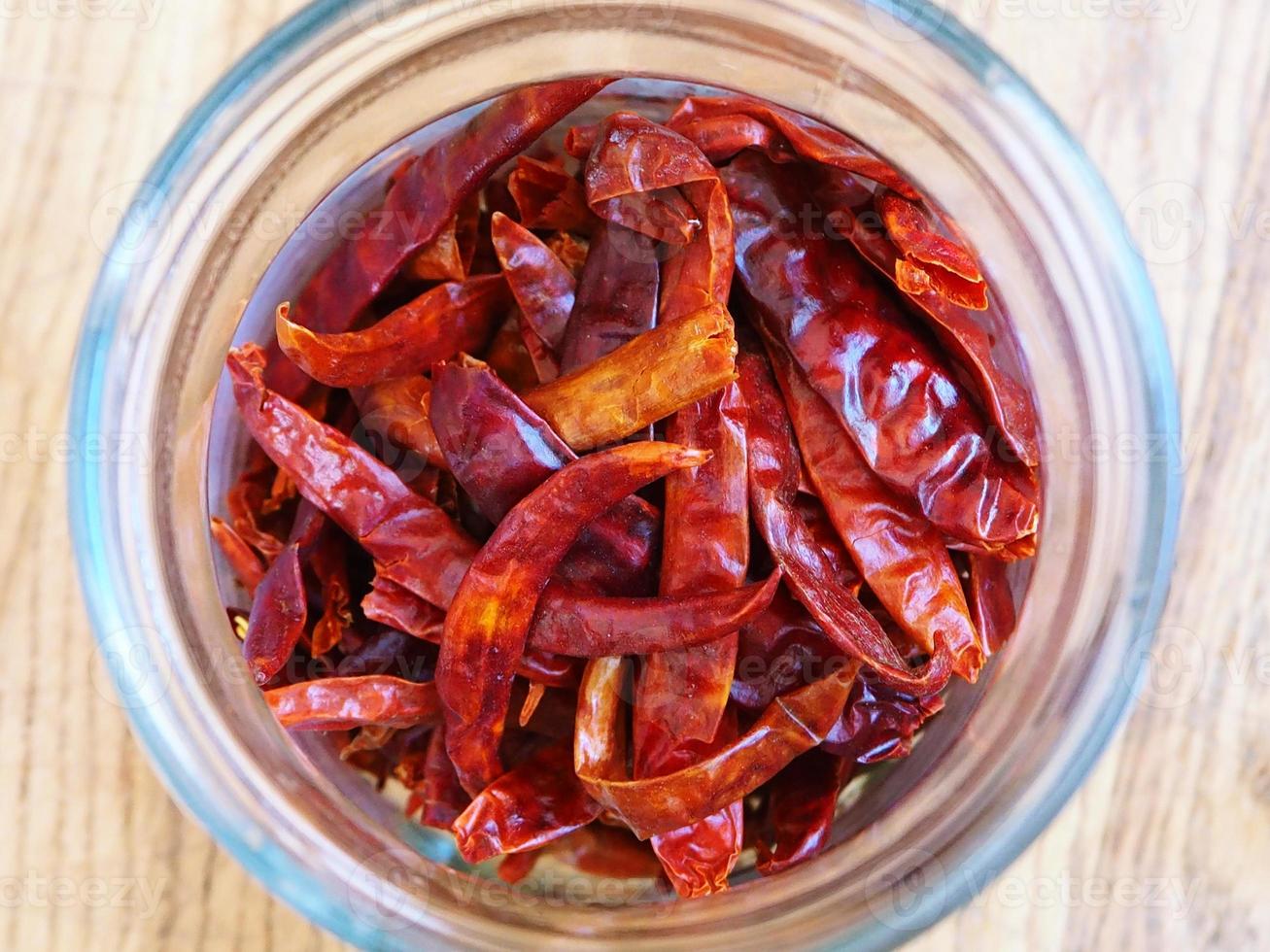 Dried Thai chili pepper in a glass jar photo