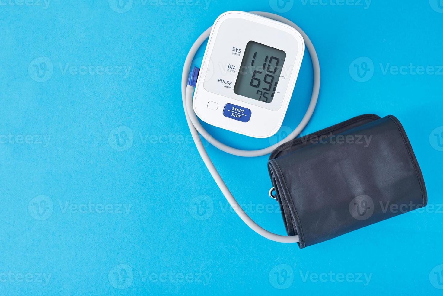 Digital blood pressure monitor on a blue background, closeup. Helathcare and medical concept photo