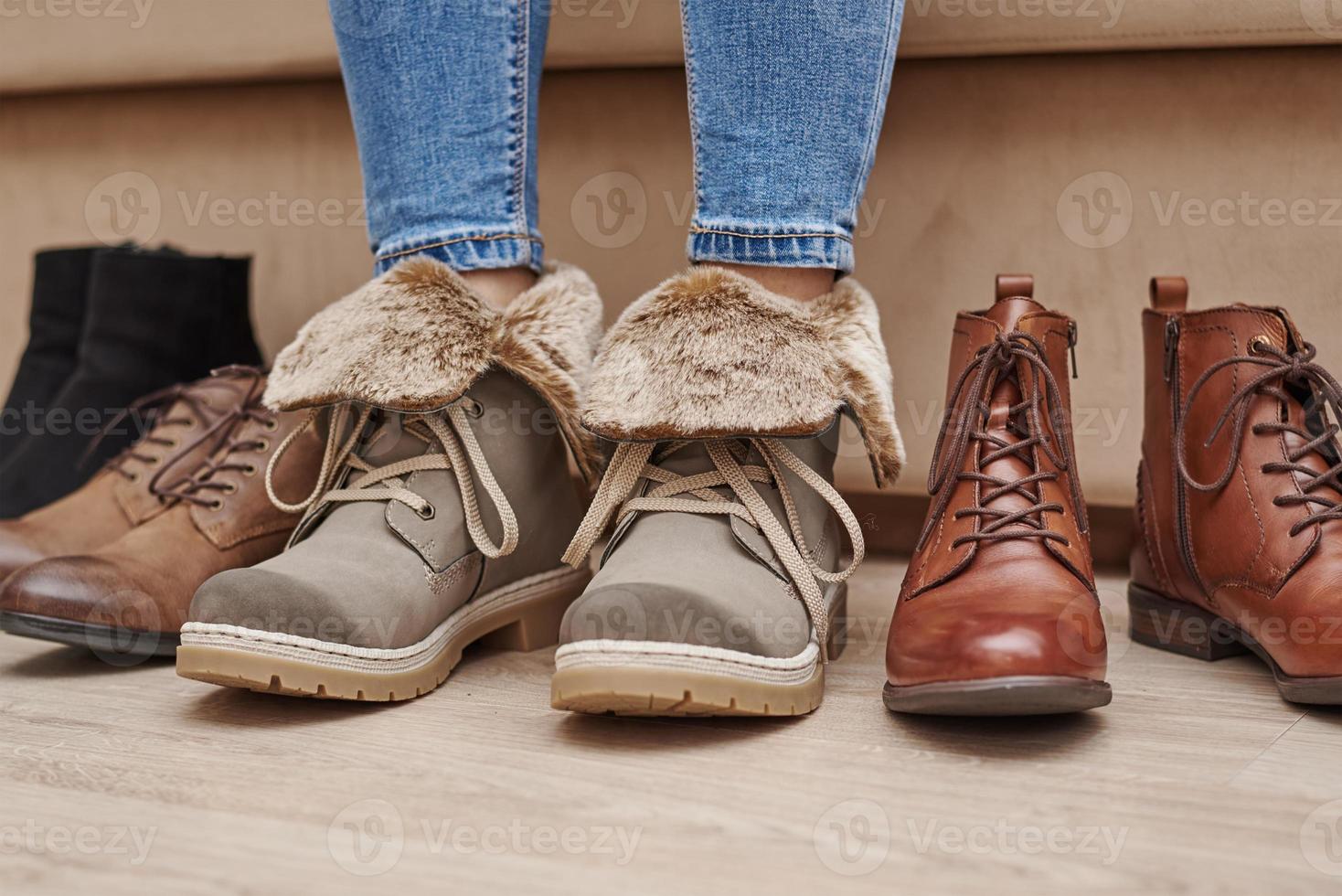 Woman chooses comfortable shoes among a bunch of different pairs photo