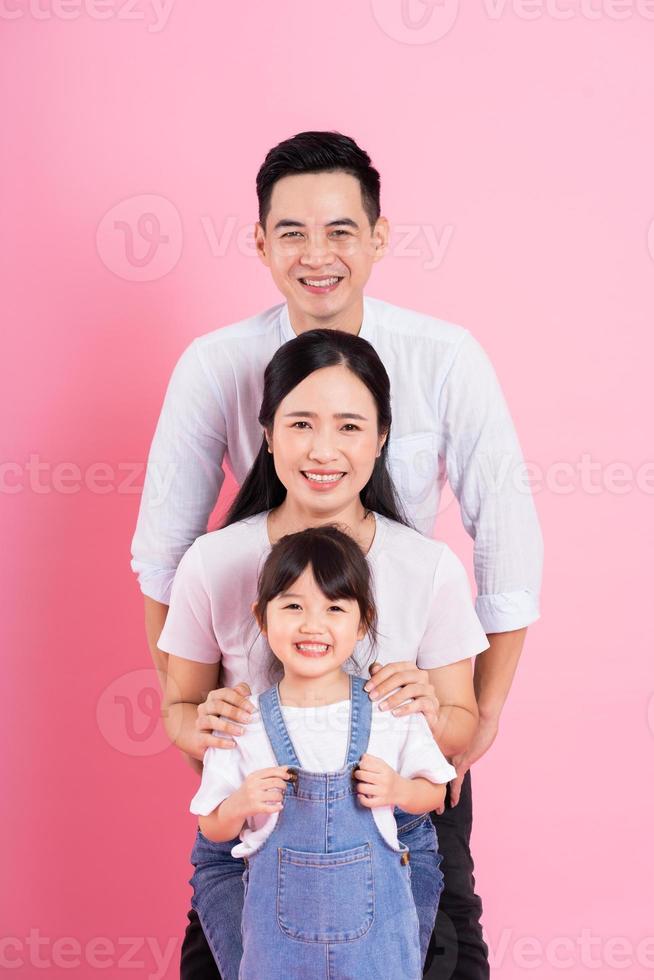 young asian family image isolated on pink background photo