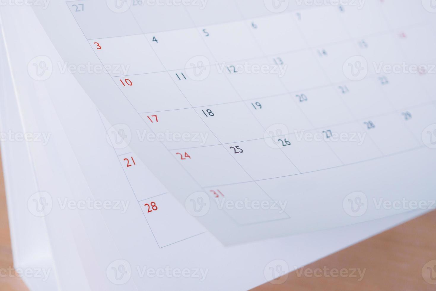 Calendar page flipping sheet close up blur background business schedule planning appointment meeting concept photo