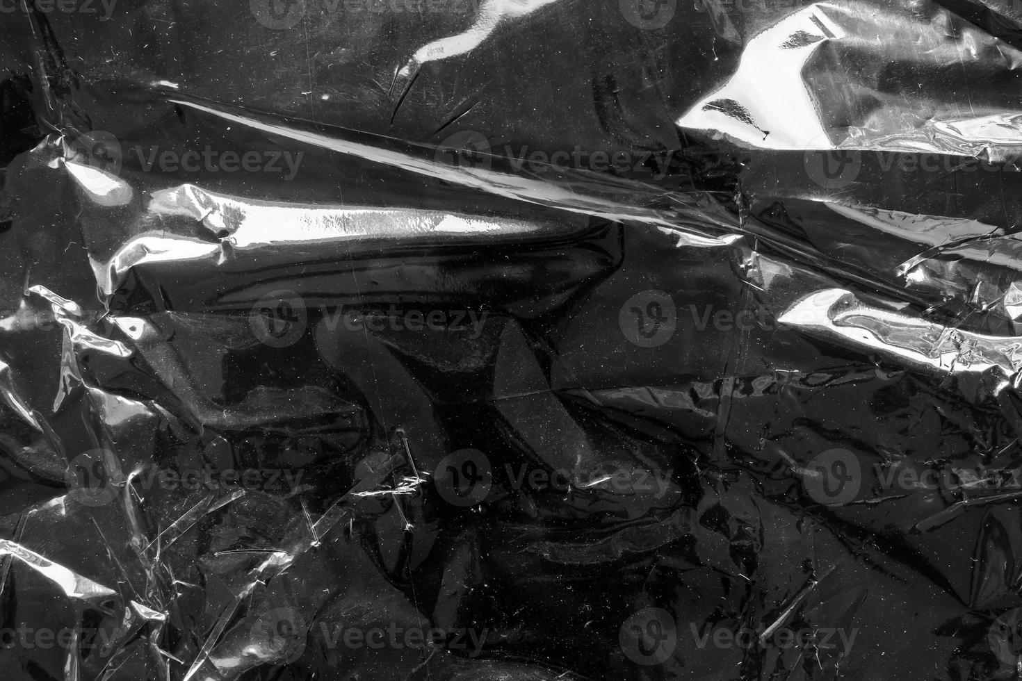 transparent plastic bag film wrap overlay texture on black background photo